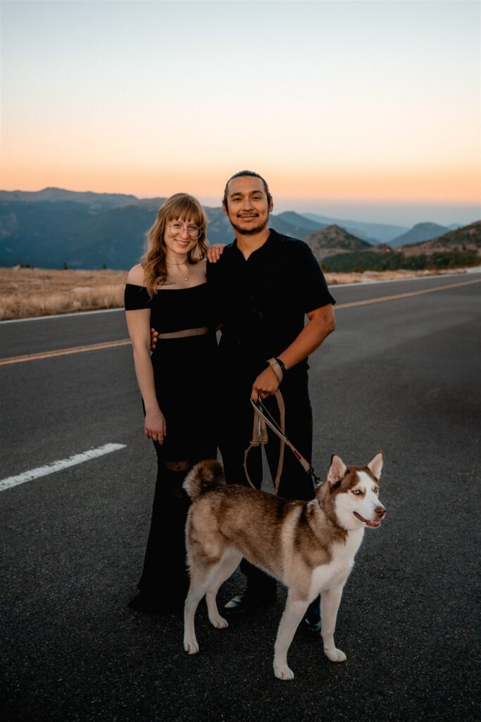 couple and dog on rocky mountain national park overlook